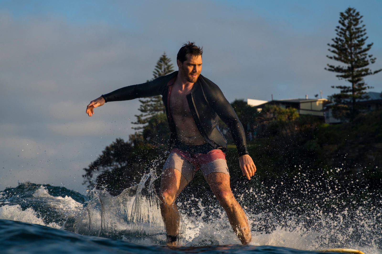 Ian surfing at sunset